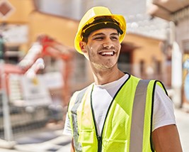 A man working outside in a hardhat