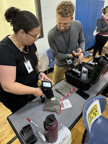 image of staff person performing lead screening on bag of dirt