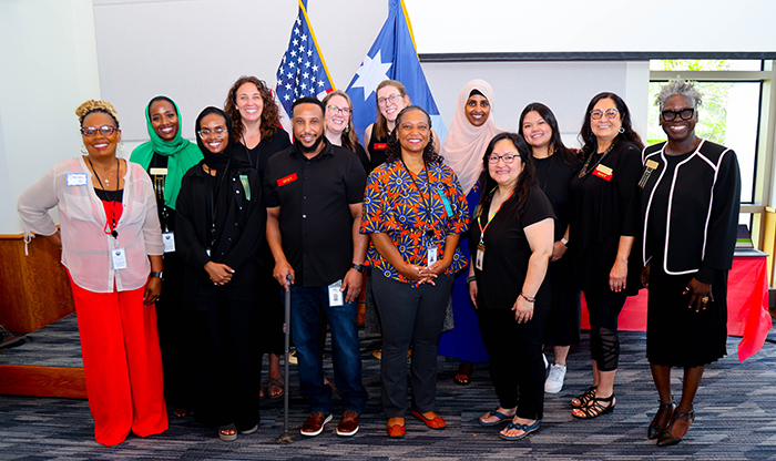 MDH staff who support the CCC initiative smile for a photo with Commissioner Cunningham