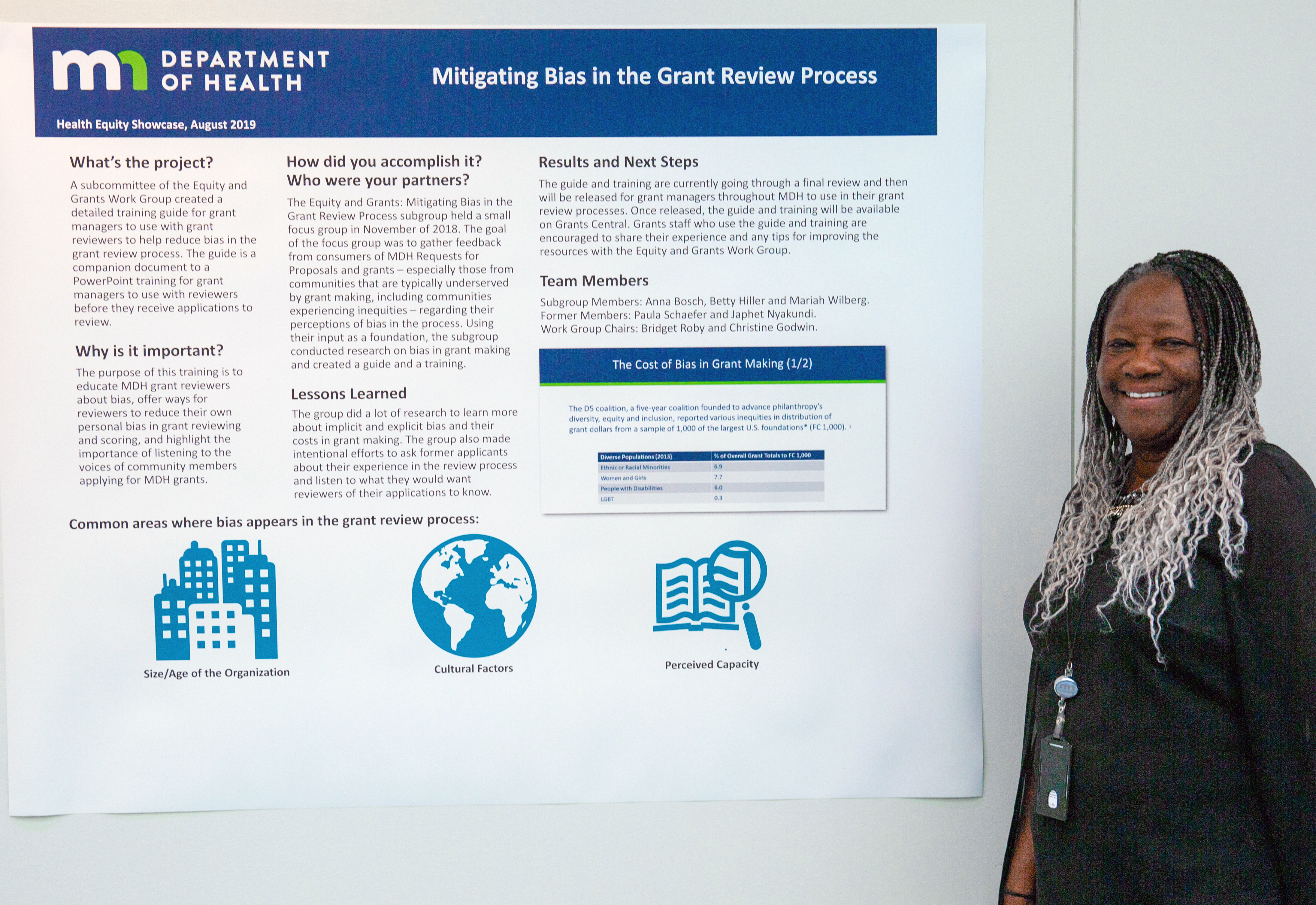 Photo of project lead with poster - mitigating bais project