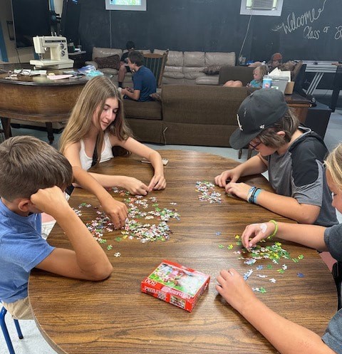 Youth at CornerStone put together a puzzle. Photo courtesy of CornerStone.