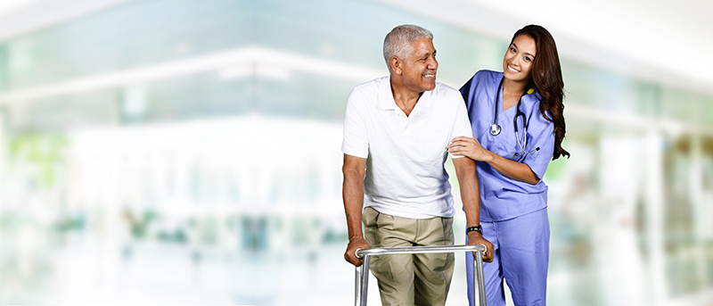 nurse assisting patient with walker